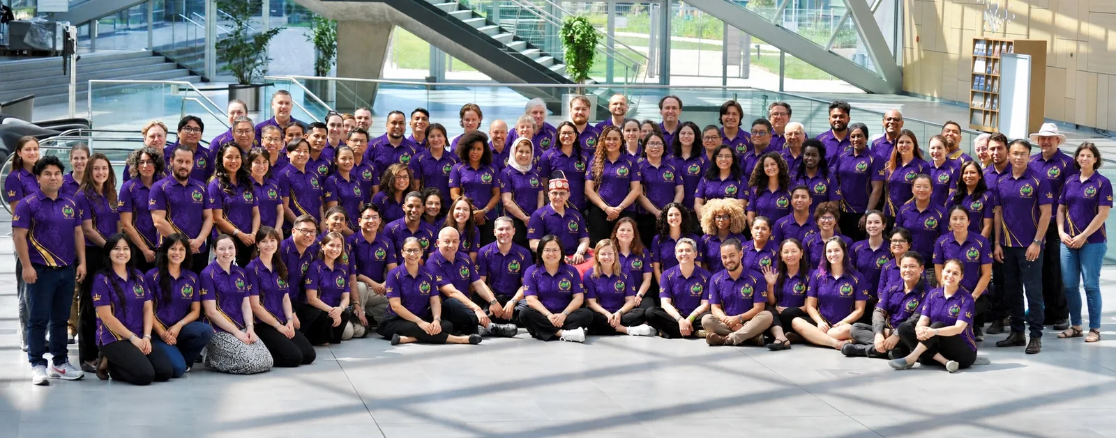 A large conference group in matching purple polos
