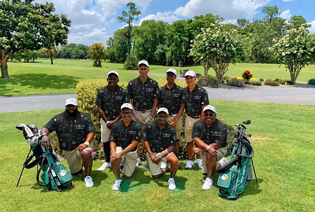 Golf team in black shirts with their bags