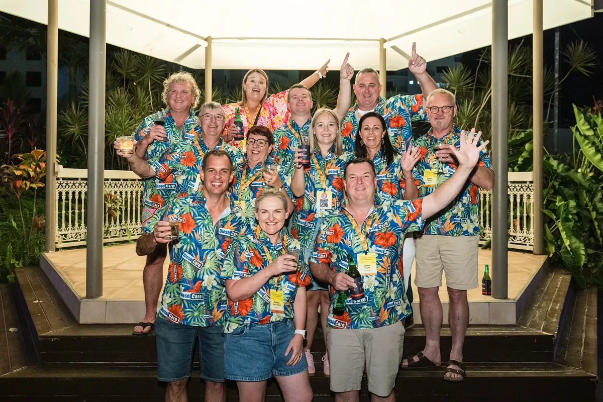 A party group in bright Hawaiian shirts at an evening gazebo