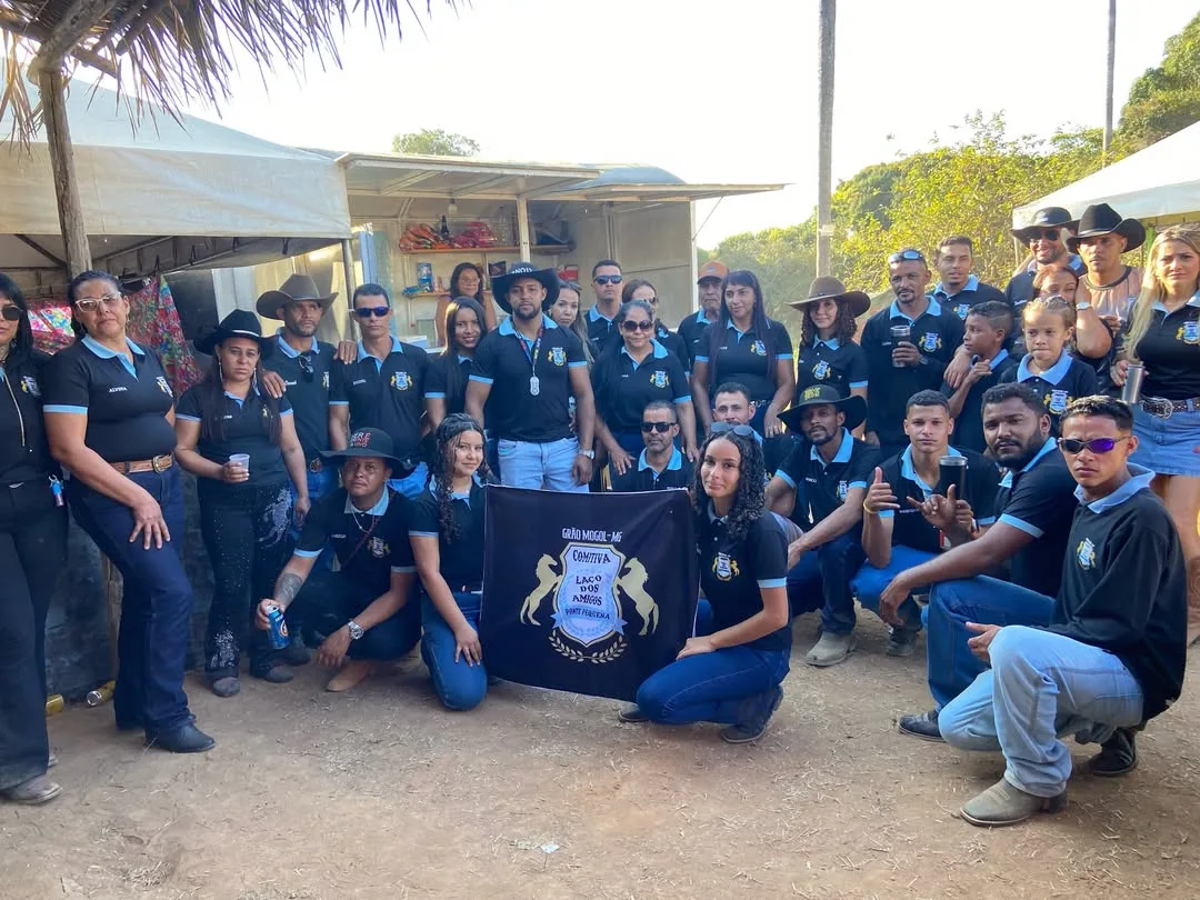 Rodeo crew in matching black shirts with their banner
